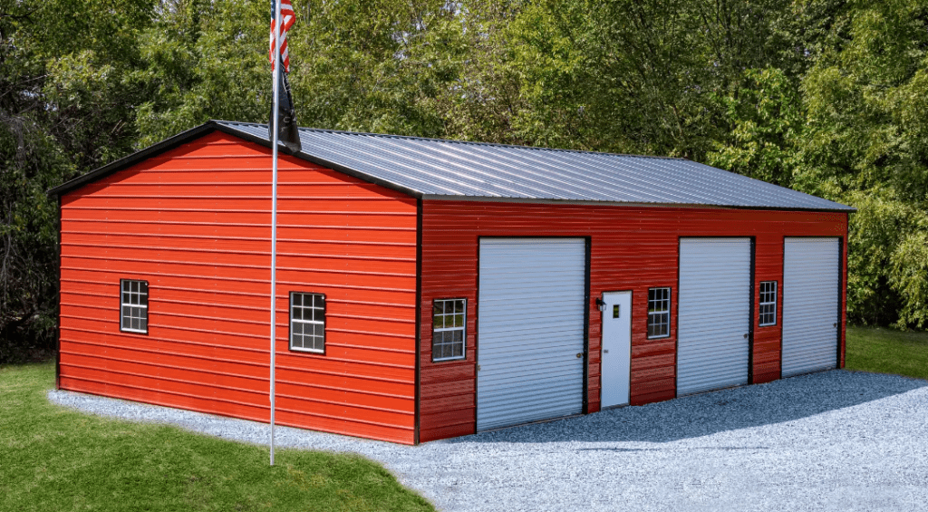 Red Metal Building with Black Roof and White Garage Doors